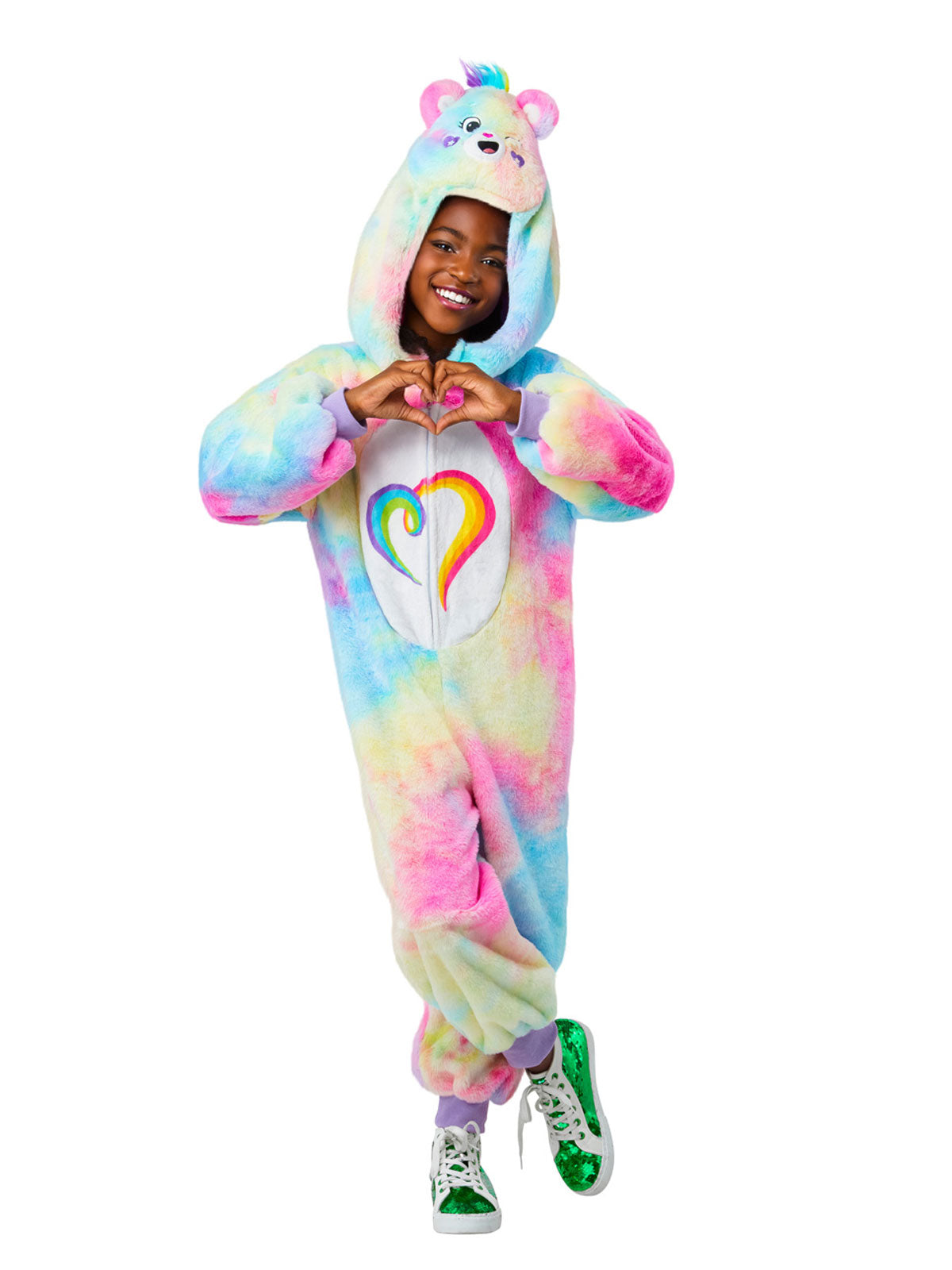 Child in pastel tie-dye Care Bears Togetherness Bear plush jumpsuit with rainbow heart badge and headpiece
