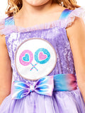 Close-up of the Care Bears Share Bear dress with lollipop belly badge and rainbow ribbon bow