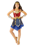 Girl wearing a deluxe Wonder Woman 1984 dress with red sequin top, gold eagle collar, gold belt and blue skirt flaps