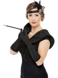 Woman wearing a black and gold 1920s kit with feather headband, faux fur stole, long gloves and cigarette holder