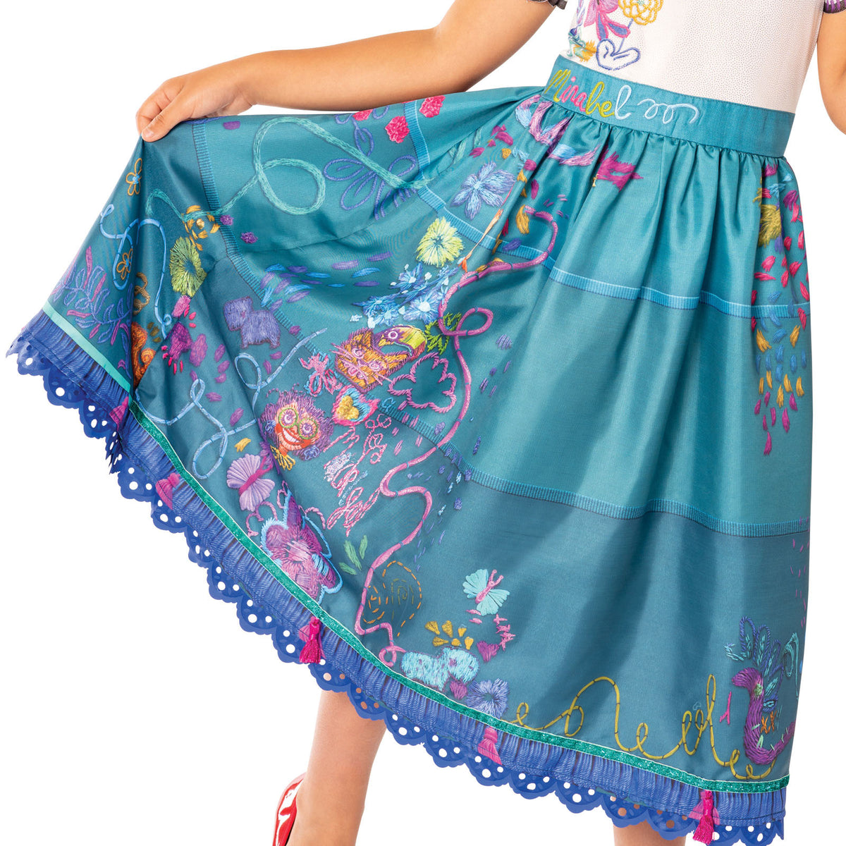 Close-up of the Mirabel Deluxe teal skirt with printed flowers and scalloped purple hem