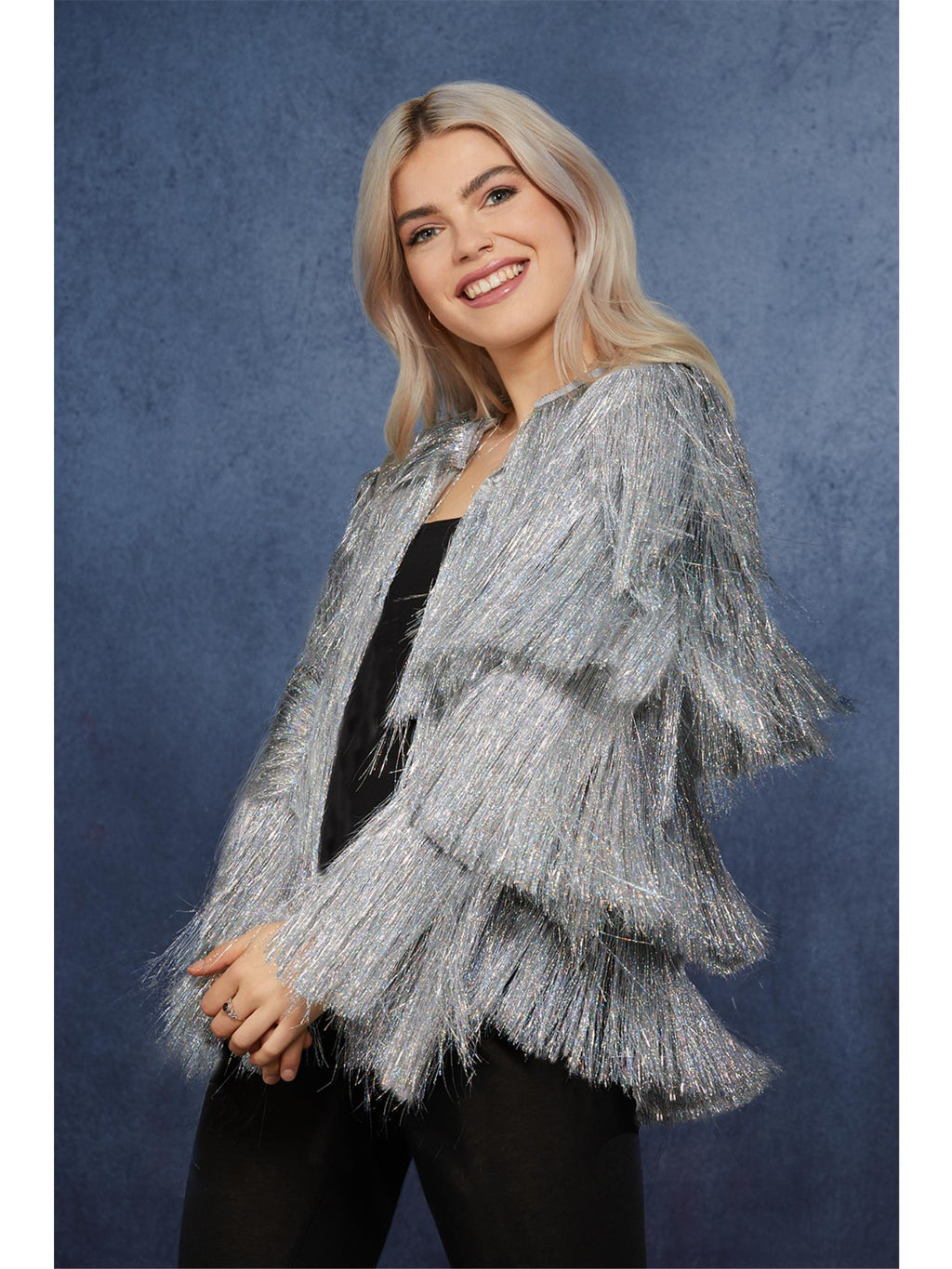 Woman wearing a silver tinsel festival jacket