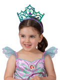 Girl wearing the iridescent green and purple Ariel tiara with a clamshell centre