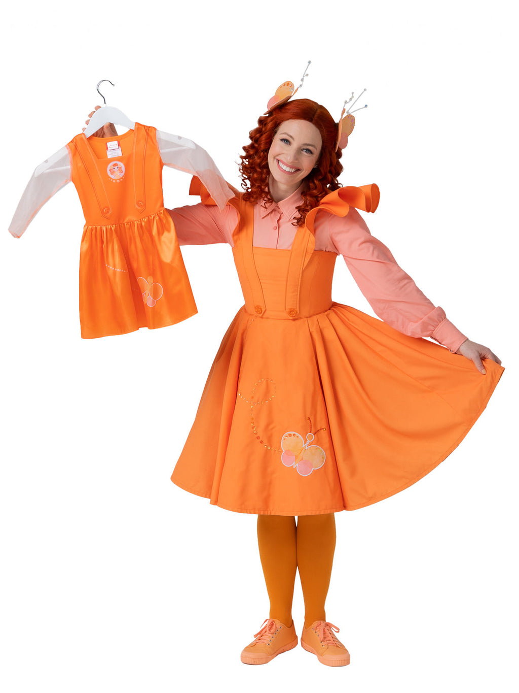 Adult in an orange Emma Memma costume showing the matching children's dress on a hanger