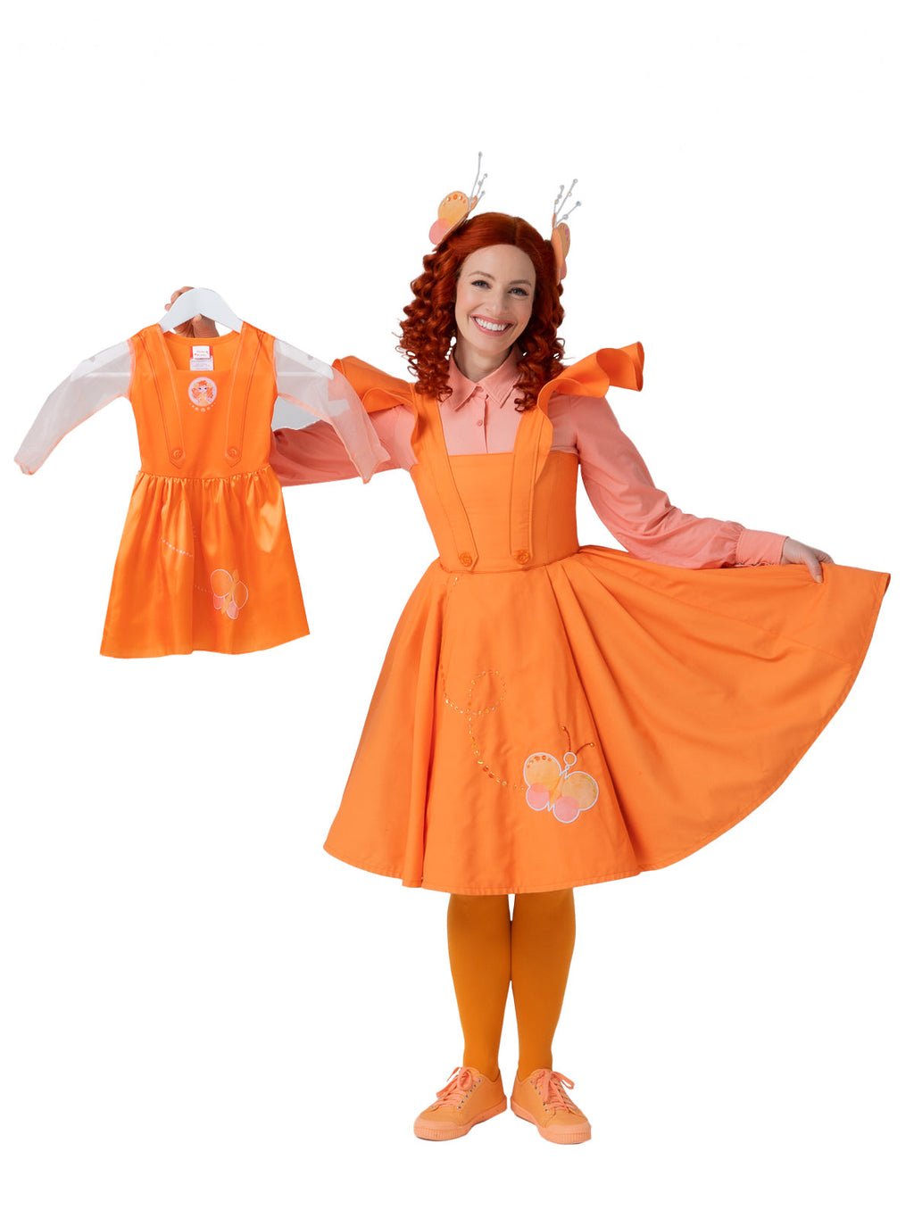 Adult in the full Emma Memma costume holding up the children's short dress