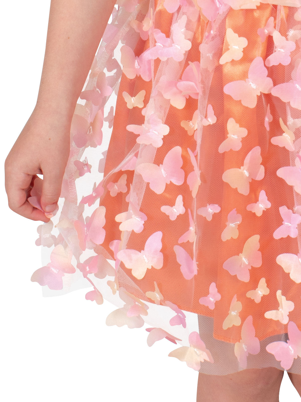 Close-up of the skirt with sewn-on pink and orange butterflies