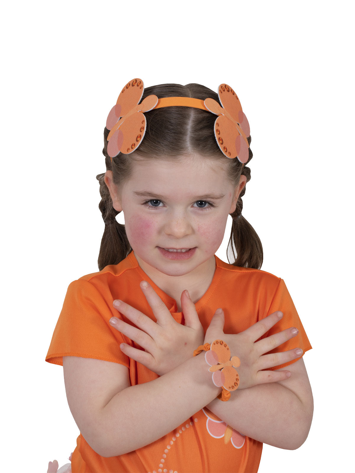 Girl wearing the orange Emma Memma butterfly headband and matching wristlet