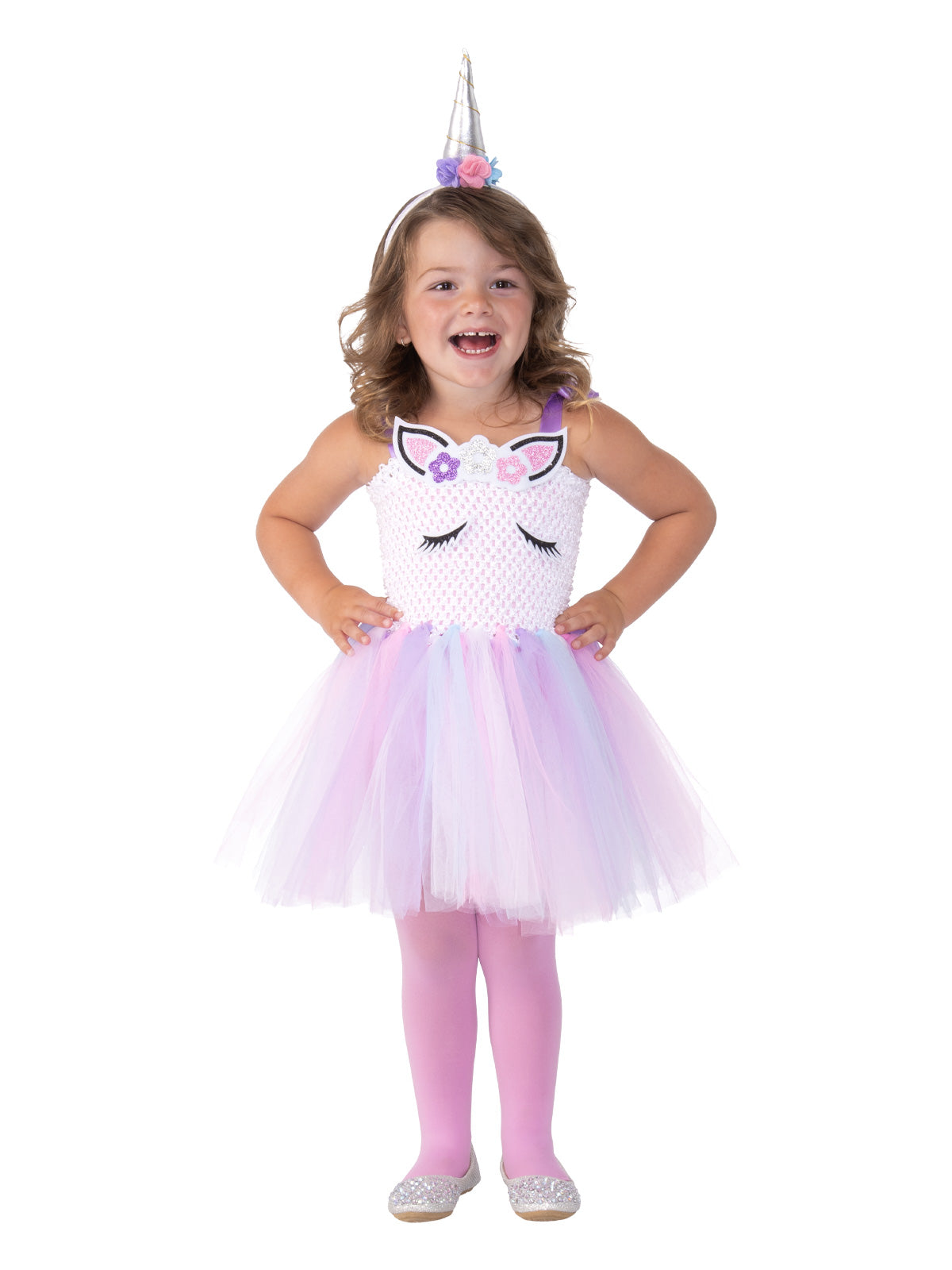 Girl wearing a pastel unicorn tutu dress with crochet-knit bodice, glitter ears and lashes, and silver horn headpiece