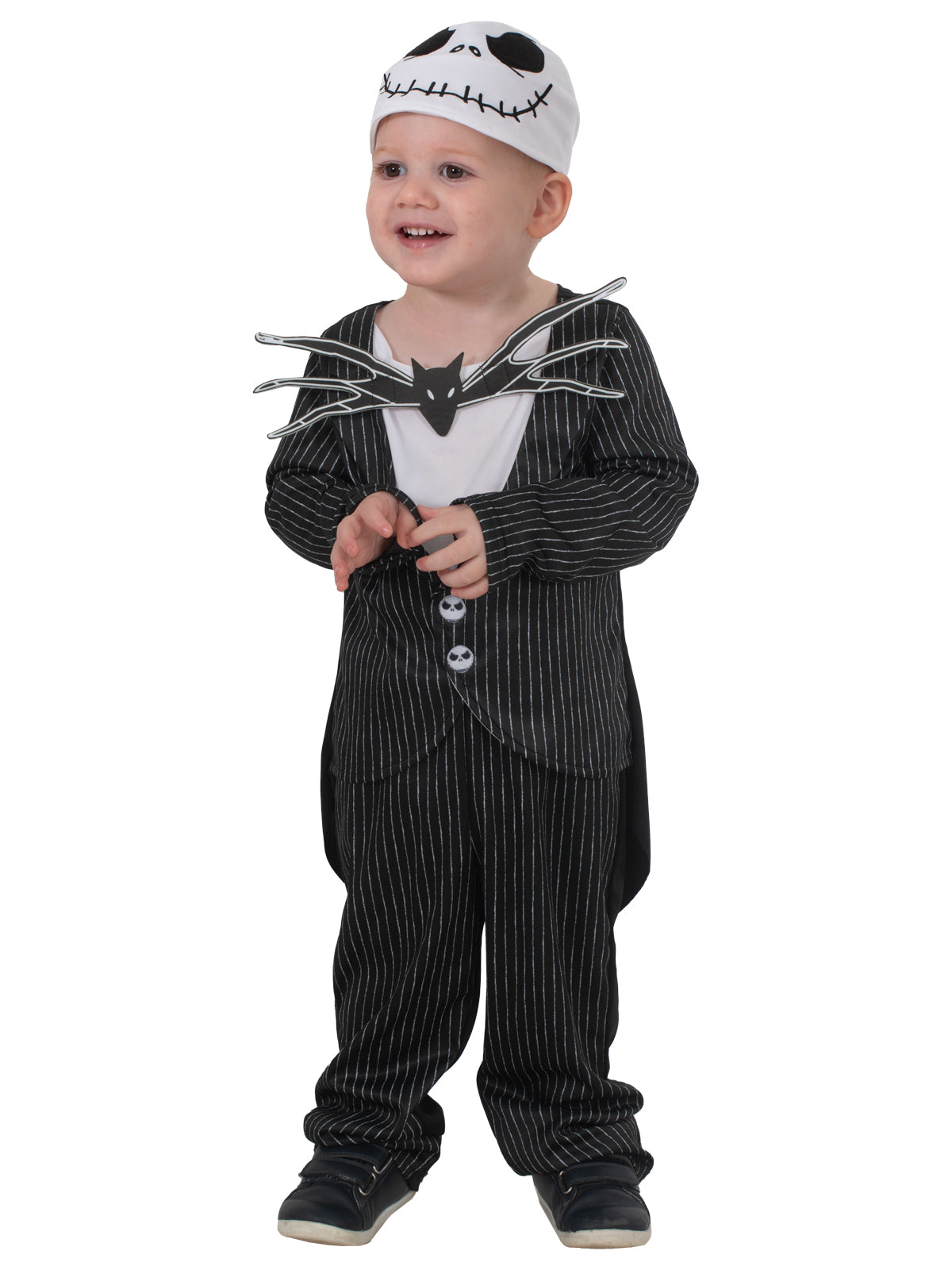 Smiling toddler in the Jack Skellington costume with the skull-print beanie and black bow tie