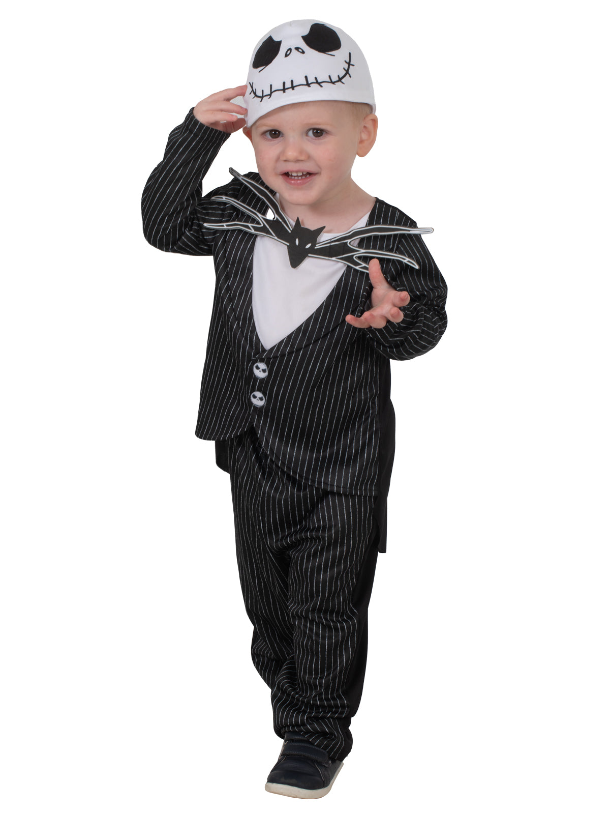 Toddler tilting head in the Jack Skellington costume with a hand raised to the beanie