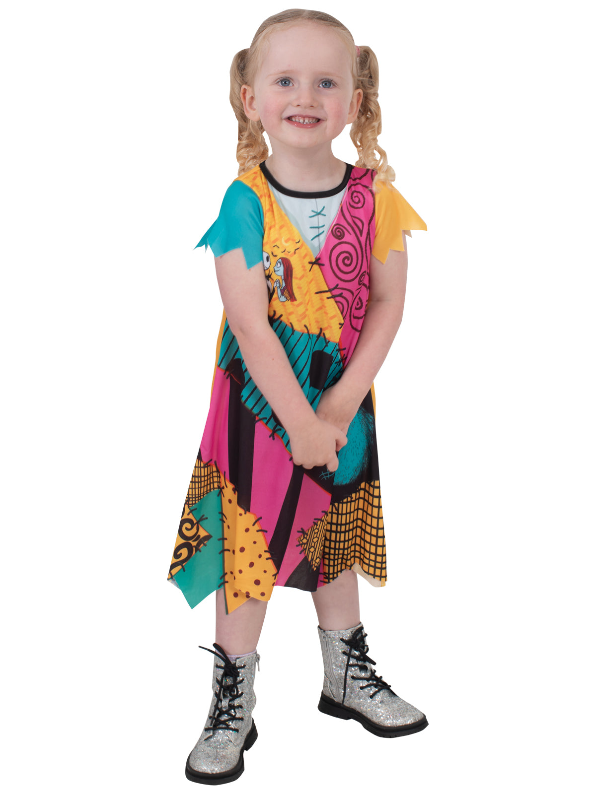 Toddler wearing the Sally patchwork dress with a ragged raw-edged hem, turned slightly to the side