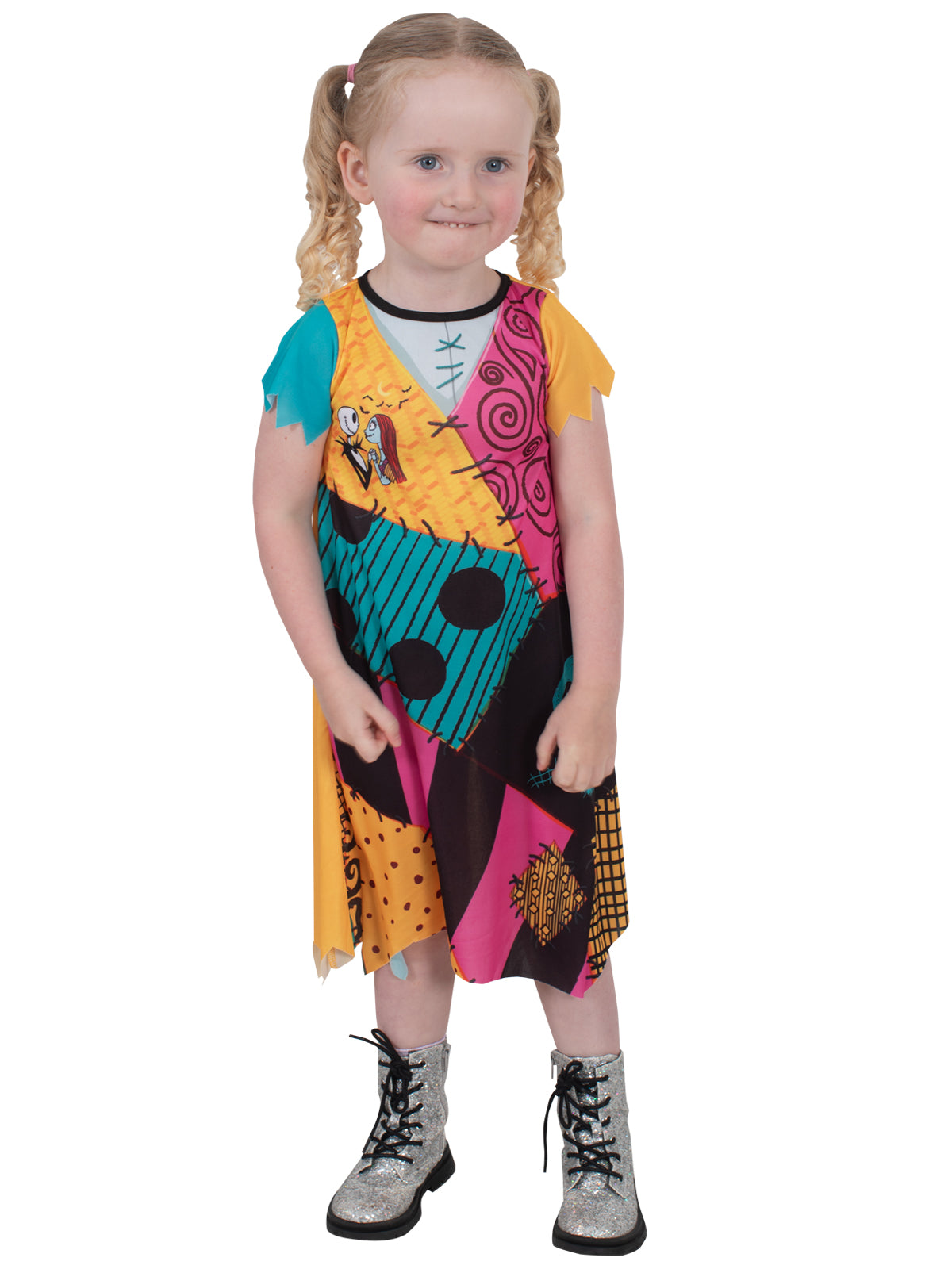 Toddler in the Sally dress showing the orange and teal patchwork print with stitching details