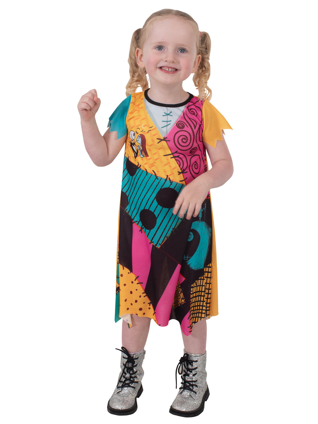 Toddler in the Sally Finkelstein costume with one hand raised, patchwork dress and short sleeves