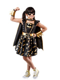 Girl wearing a premium Batgirl sequin tutu dress with gold bat print skirt, black cape, gold gauntlets and mask