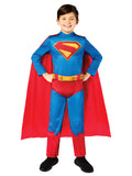 Boy in the classic Superman 2025 movie jumpsuit with a detachable red cape, standing with hands on hips