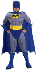 Boy in grey and blue Batman muscle chest jumpsuit with yellow bat emblem and belt, blue cape, cowl and boot tops