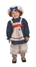 Girl wearing a ragamuffin dolly costume with navy dress, white apron, pantaloons and yarn-hair bonnet
