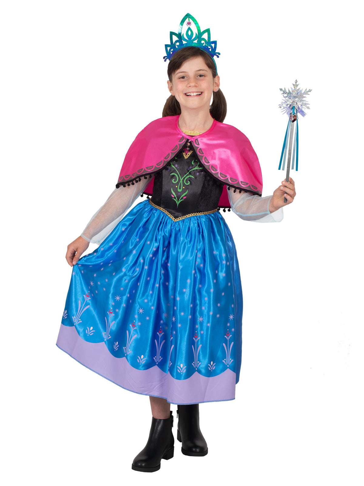 Girl in the Anna deluxe dress and pink cape, holding out the blue printed skirt