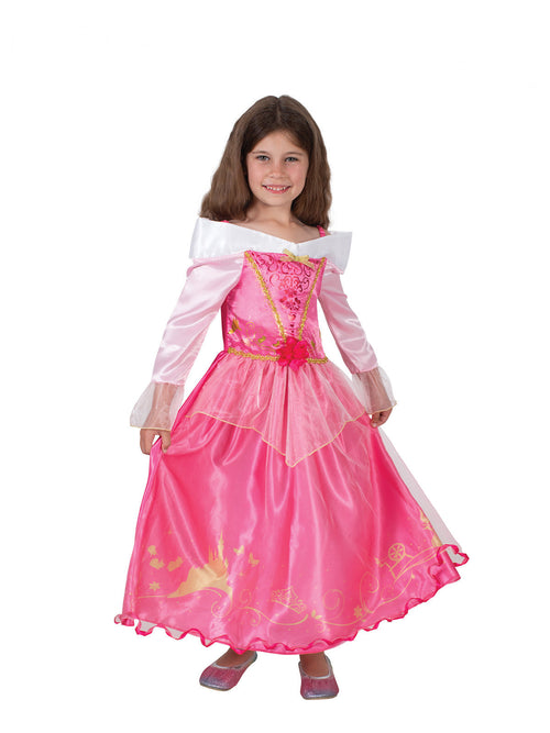 Girl wearing a pink Aurora Storyteller dress with off-shoulder collar, trumpet sleeves and storybook print hem
