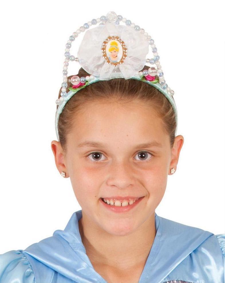 Girl wearing the white and blue beaded Cinderella tiara with a character pendant