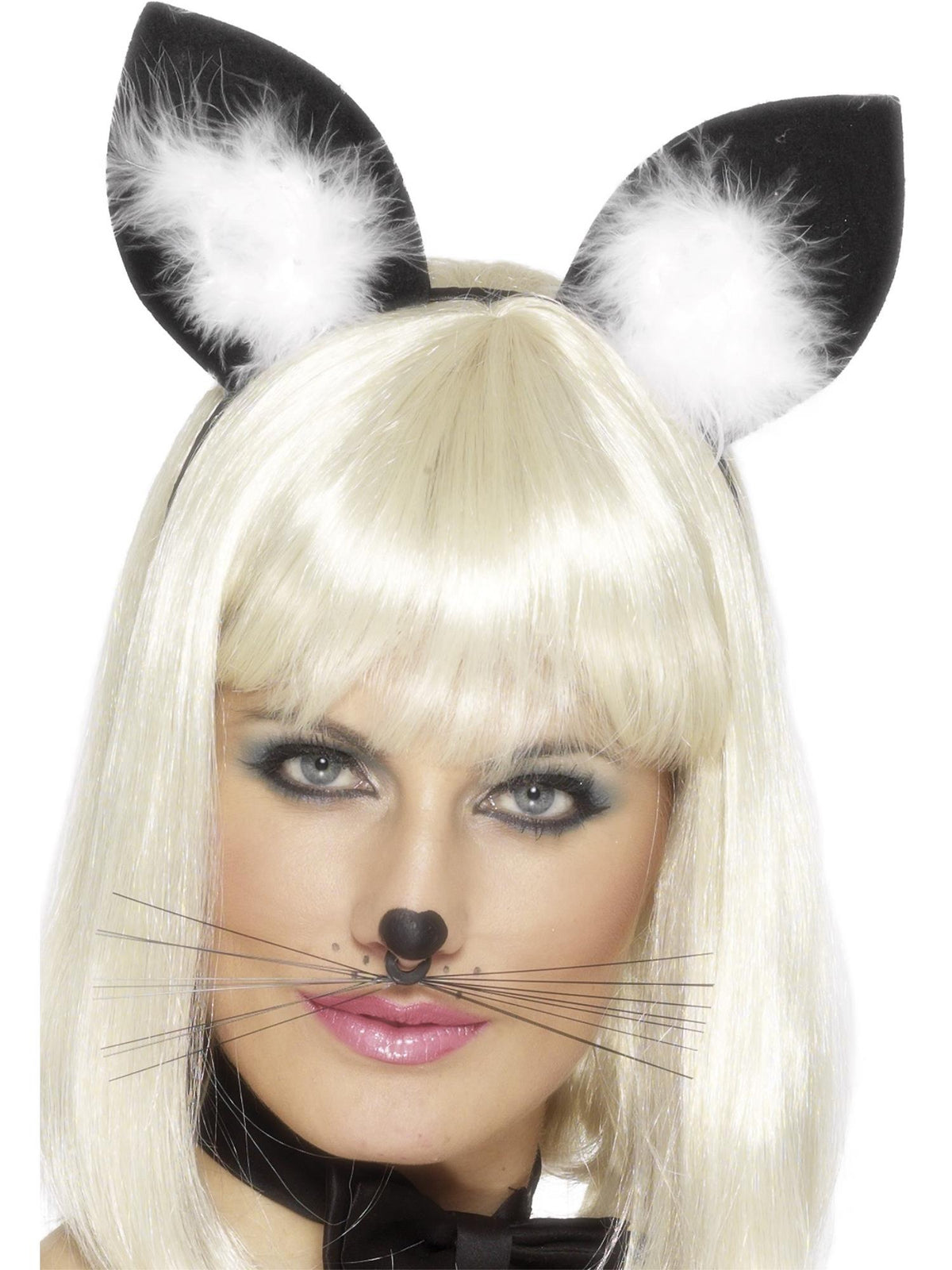Woman wearing black cat ears with white fluffy centres on a headband