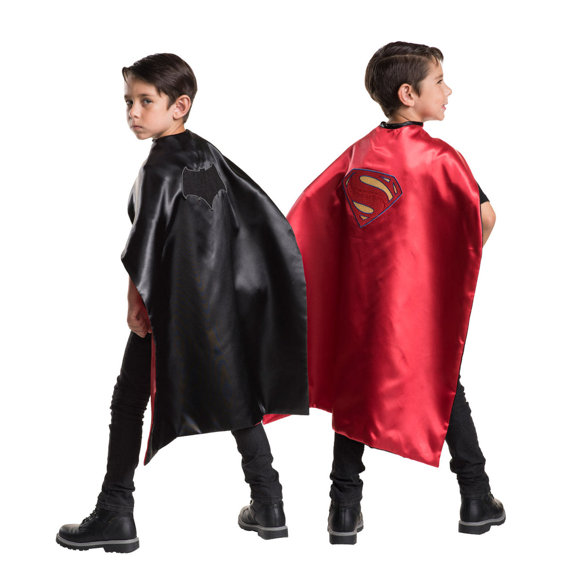 Two boys showing both sides of the reversible cape, black Batman and red Superman